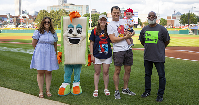 The Strader-Wood Family poses for a photo with Foundation President Roberta Jaggers and Library Chief Executive Officer Gregory Hill on Library Night at the Indianapolis Indians game on July 30, 2024.