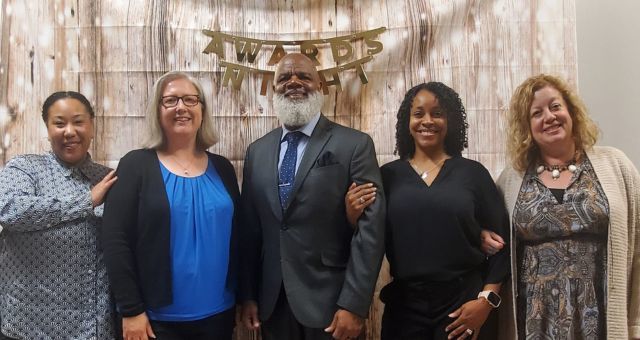 Pictured beginning on the left, Sakura Fuqua, Immigrant Outreach Program Specialist, Fiona Duke, Southport Branch Manager, Gregory A. Hill, CEO, Naomi R. Konja, Area Resource Manager for the West Region, and Lindsay Haddix, West Perry Branch Manager.